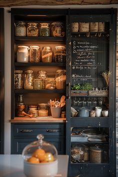 an open cabinet in a kitchen filled with pots and pans