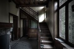 an empty hallway with stairs leading up to the second floor