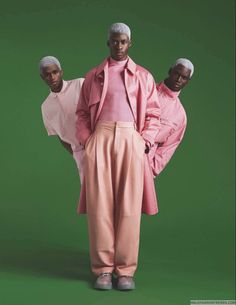 two men in pink outfits standing next to each other on a green background with the same outfit