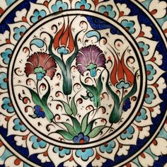 an intricately decorated plate with flowers on it