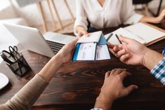 people sitting at a table with notebooks and papers