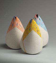 three colorful vases sitting on top of each other