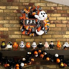 halloween decorations are arranged in front of a brick wall