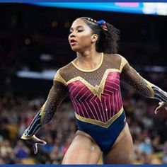 a woman is performing on the balance beam