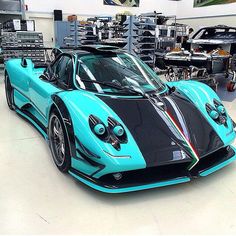 a blue and black sports car in a garage