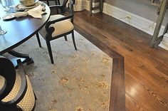 a dining room table with chairs and a bench