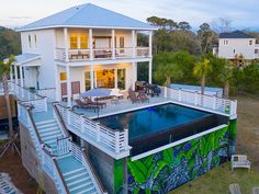 an aerial view of a house with a pool in the yard and stairs leading up to it