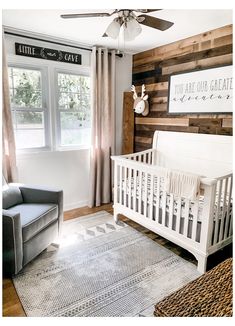 a baby's room with a white crib and wooden walls