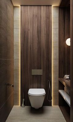 a modern bathroom with wood paneling and white fixtures on the walls, along with a toilet