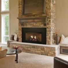 a living room filled with furniture and a fire place in the middle of a fireplace