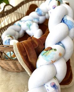 a basket filled with stuffed animals sitting on top of a floor