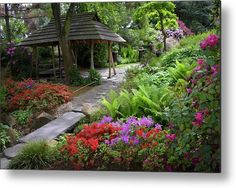 a gazebo surrounded by flowers and trees in a garden metal print featuring the gazebo