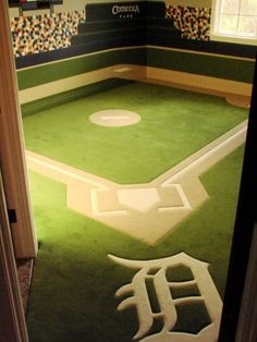 a baseball field themed room with the detroit tigers logo painted on the floor