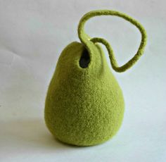 a small green bag sitting on top of a white table