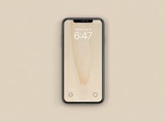 an iphone with the number 647 displayed on it's display screen, in front of a beige background