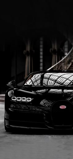 a black sports car parked in front of a building