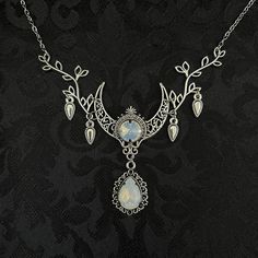 "This enchanting moon elf necklace features richly detailed antiqued silver tone filigree crescent, intricate leafy branches and elegant scroll drop accents. Its captivating design is adorned with dazzling white opal glass crystals. Decorated portion is 4 1/2\" wide and 2 1/2\" tall in the very center.  Necklace length is adjustable with soldered stainless steel cable chain, lobster clasp and extender. If you would like a different length, please send us a message. Matching headpiece, pendant an Fantasy Silver Jewelry With Moon Charm, Silver Elven Jewelry For Festivals, Silver Elven Style Jewelry For Festivals, Mystical Silver Jewelry With Intricate Design, Elf Necklace, Moon Goddess Jewelry, Raw Carnelian, Elf Jewelry, Dancer Necklace