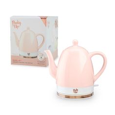 a pink tea pot next to a box