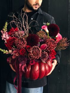 a man holding a bouquet of flowers in his hands