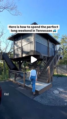 a woman is walking down the street in front of a small house with stairs on it