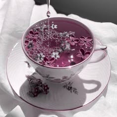 a cup filled with liquid sitting on top of a saucer