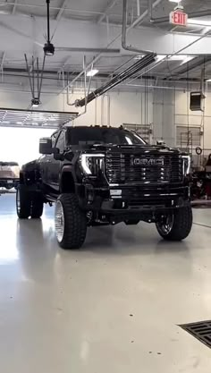 a large black truck parked in a garage