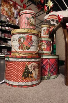 several christmas themed ribbons are stacked on top of each other in front of a chair