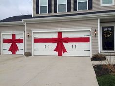 two garage doors decorated with red ribbon and bows