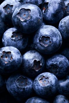 blueberries are piled up in a pile