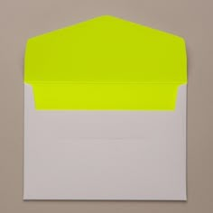 an envelope with yellow and white paper on the inside is open to reveal a blank note