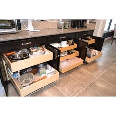 an open drawer in the middle of a kitchen