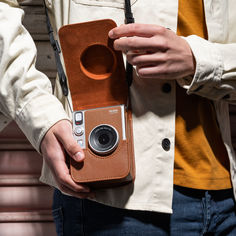 a person holding a camera in their hand