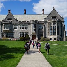 several people are walking towards a large building