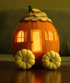 a pumpkin shaped like a house on wheels with windows and sun coming through the window