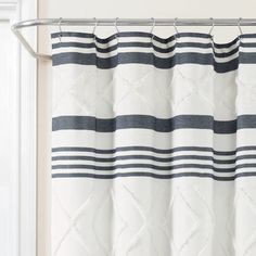 a white curtain with blue and black stripes