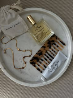 an assortment of personal care items on a marble tray