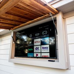 the screen on the side of a house is displaying various logos and numbers, including 4k