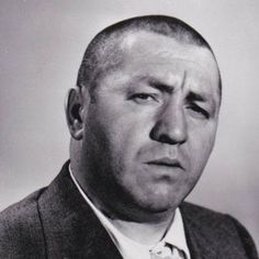 black and white photograph of a man in a suit looking off to the side with his eyes closed