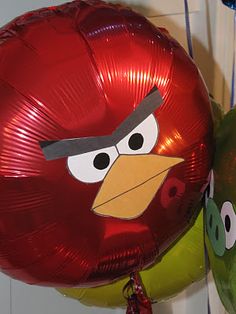 two balloons with angry birds on them are hanging from the wall next to each other