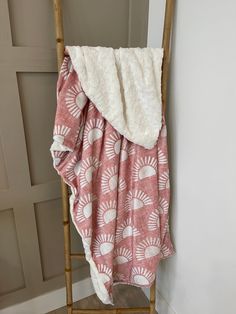 a chair with a blanket on top of it next to a white wall and door