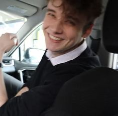 a man sitting in the back seat of a car