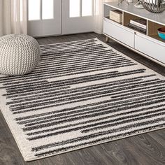 a white and black rug in a living room