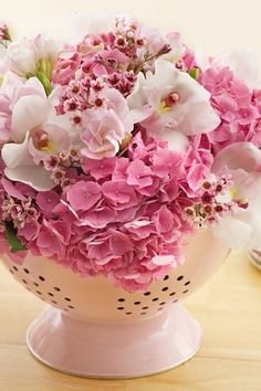 pink and white flowers in a vase on a table