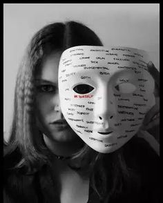 a woman with a mask over her face that has words written all over it to spell out the word