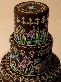 three tiered cake decorated with flowers and vines