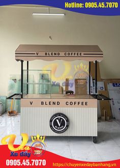 the coffee stand is made from wood and has a sign on it that reads v blend coffee