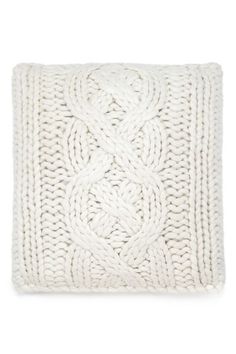 a white knitted pillow on a white background