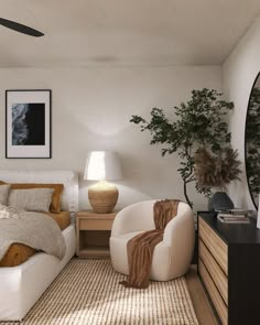 a bed room with a neatly made bed next to a dresser and a mirror on the wall