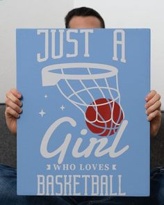 a man holding up a sign that says just a girl who loves basketball