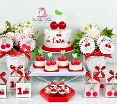 a table topped with cakes and cupcakes covered in frosting